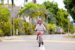 Child riding bike. Kid on bicycle in sunny park