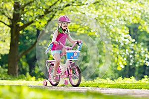 Child riding bike. Kid on bicycle. photo