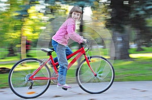 Child riding bike in park