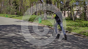 Child riding on kick scooter in park