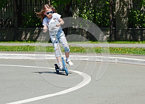 Child riding scooter. Kid on colorful kick board. Active outdoor fun for kids. Summer sports for preschool children. Little happy