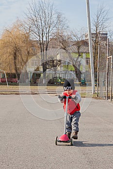 Child riding scooter outdoors, active sport kids