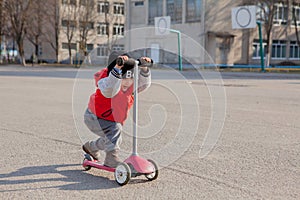 Child riding scooter outdoors, active sport kids