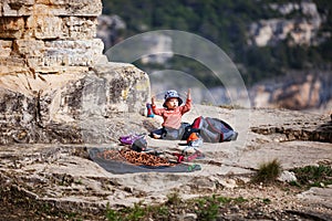 Child of rock climbers playing with climbing rope