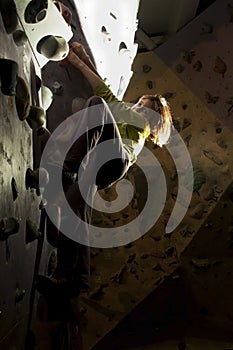 Child rock climbing up the wall