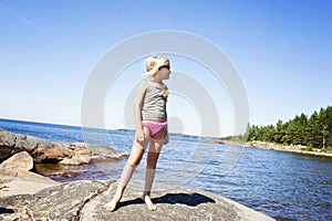 Child on rocky beach in Sweden