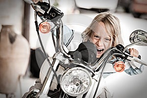 Child rogue riding a motorcycle photo