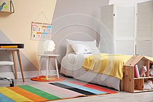 Child room interior with comfortable bed and desk
