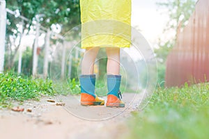 Child in rubber boots walking . child`s feet in a rubber boot