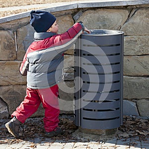 Child at rubbish bin photo