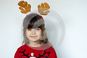 Child with a Rudolf deer horn on head on white background. Xmas holiday and sale concept