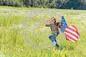 child running in field with american flag