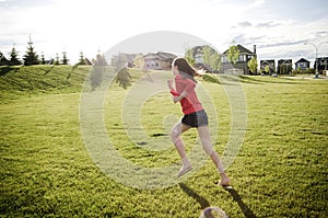 Child running in the field in summer