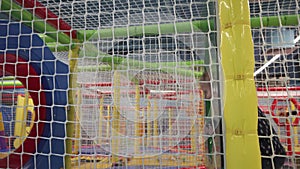 Child running through a maze on children`s obstacle course at playground