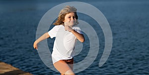 Child running outdoor. Happy childhood. Healthy sport activity for children. Little boy at athletics competition race