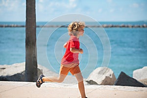 Child running outdoor. Healthy sport activity for children. Little boy at athletics competition race. Runner kids