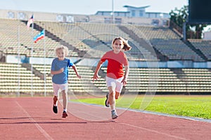 Child running in stadium. Kids run. Healthy sport