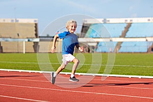 Child running in stadium. Kids run. Healthy sport