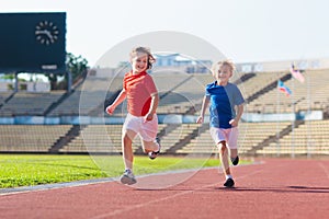 Child running in stadium. Kids run. Healthy sport