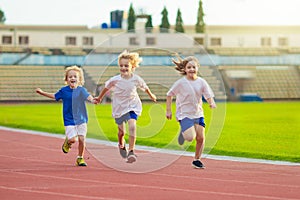 Child running in stadium. Kids run. Healthy sport