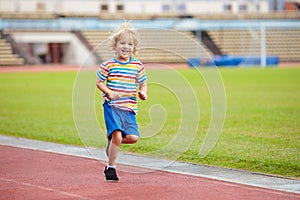 Child running in stadium. Kids run. Healthy sport