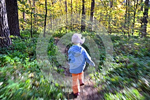 Child runs through the forest