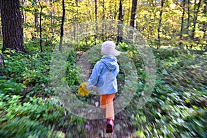 The child runs through the forest