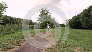 Child runs with a paper plane. girl in a green park, forest