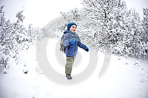 A child runs through the snow.