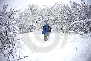 A child runs through the snow.