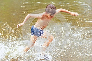 The child runs into the water. Movement splashes and joy. Toning