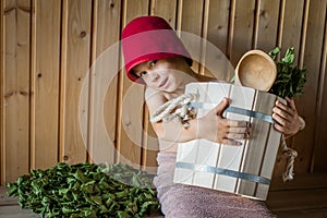 Child in a Russian bath with a birch broom