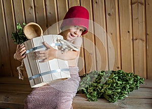 Child in a Russian bath with a birch broom