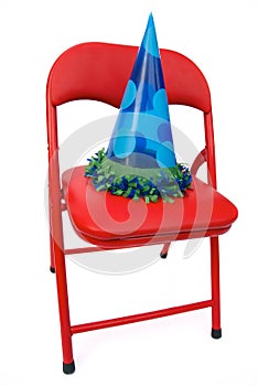 Child's chair with party hat