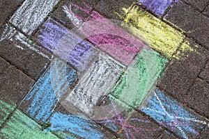 Child`s chalk picture on the pavement. Childrens multi-colored chalk drawing on the asphalt