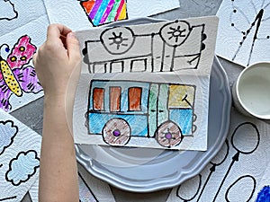 A child`s drawing of a bus, drawn on a napkin, for a child`s magical experience.