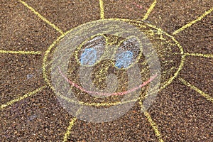 A child`s drawing of sun on a stree