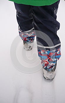 ChildÂ´s feet and snow in winter