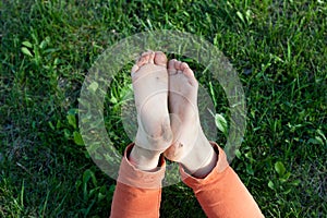 Child`s feet are soiled after walking barefoot. Happy childhood.