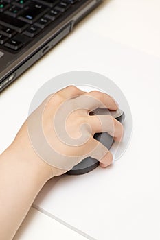 Child's Hand with Computer Mouse photo