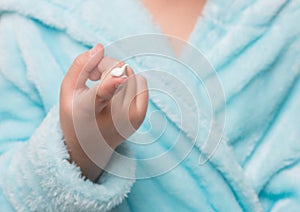 child's hand with cream on a finger