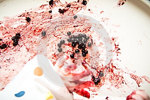 Child`s hand while eating berries
