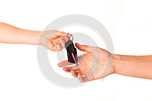 Child's hand holding a car key and handing it over