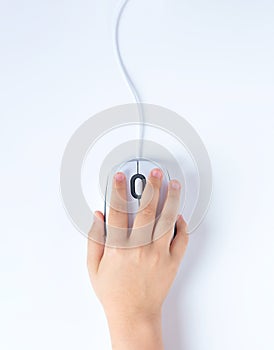 Child`s hand holds a computer mouse on a white background