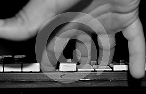 Child`s hand on the keyboard of the instrument