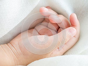 Child's hand laying down while sleeping