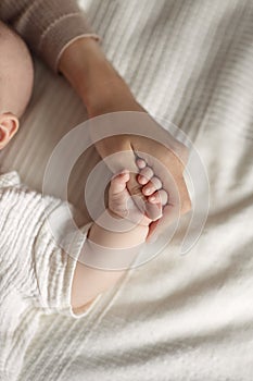 Child's hand in mother's hand, baby holding mother's finger