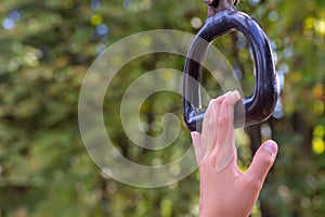 Child`s hand  nearly achieving goal of grabbing a monkey bar at a playground conecept trying and striving to holding on for