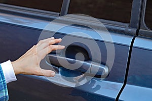 Child's hand reaching for door handle