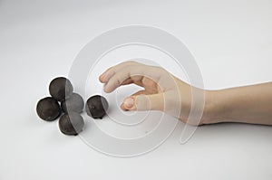 Child`s hand reaching for sweets, all on a white background
